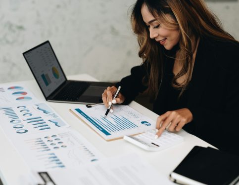 usiness analyzing investment charts with calculator laptop. Accounting and technology in office usiness analyzing investment charts with calculator laptop. Accounting and technology in office